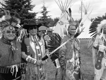 Nakota community members in traditional regalia